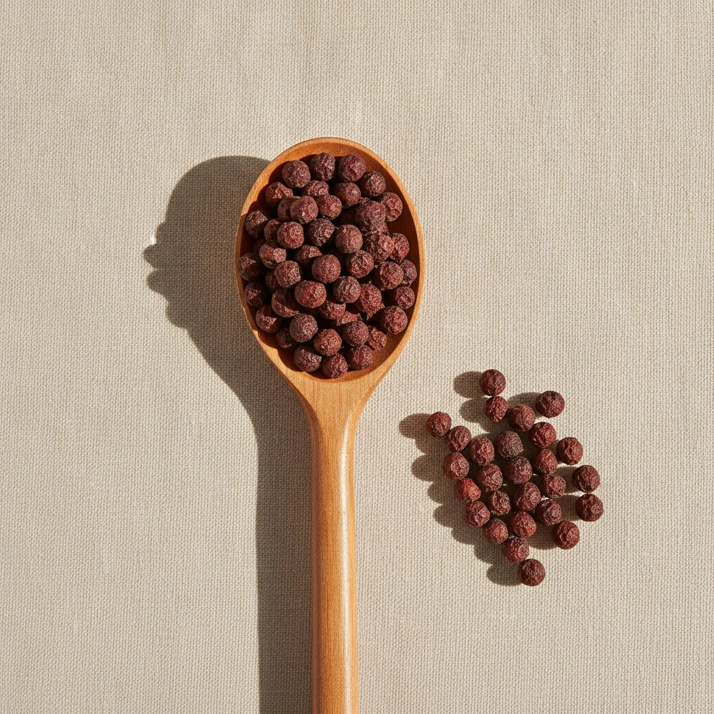 Hawthorn Berries Whole (Crataegus Laevigata) | Create a luxurious, photorealistic product photograph featuring the original product naturally arranged in an elegant handcrafted wooden spoon on a soft, finely