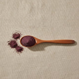 Acai Berry Extract Powder (Euterpe Oleracea) | Create a luxurious, photorealistic product photograph featuring the original product naturally arranged in an elegant handcrafted wooden spoon on a soft, finely