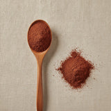 Acerola (Vitamin C) Powder (Malpighia Glabra) | Create a luxurious, photorealistic product photograph featuring the original product naturally arranged in an elegant handcrafted wooden spoon on a soft, finely