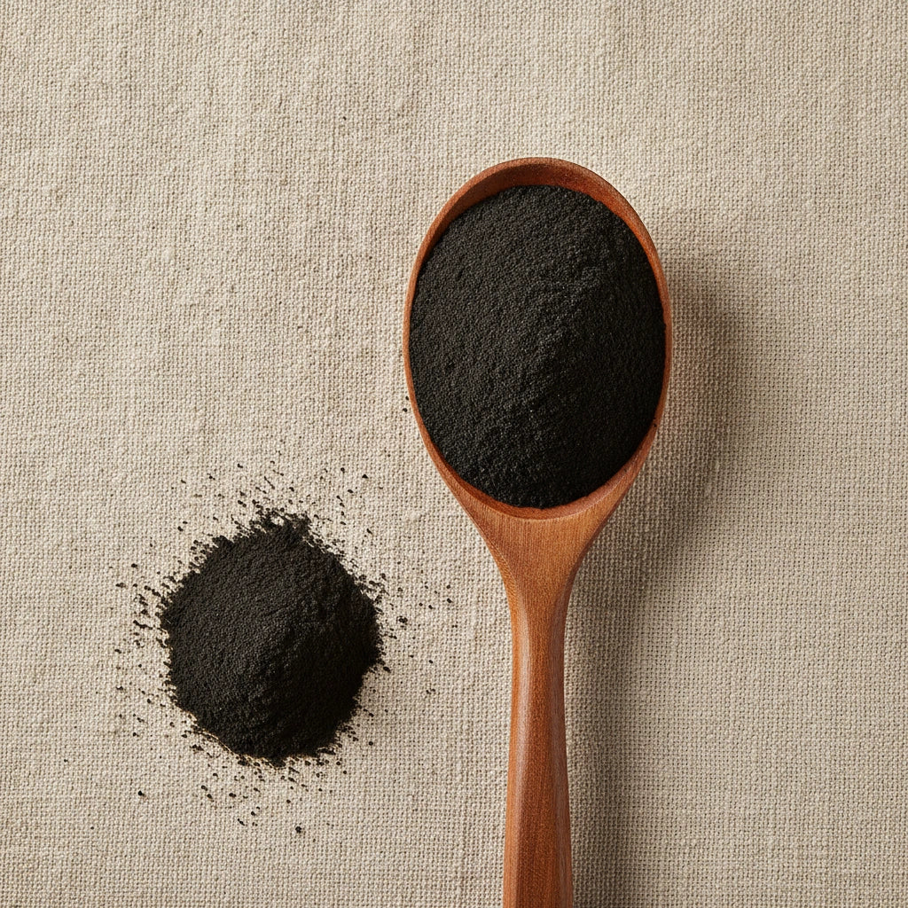 Activated Charcoal Powder (Activated carbon) | Create a luxurious, photorealistic product photograph featuring the original product naturally arranged in an elegant handcrafted wooden spoon on a soft, finely