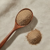 Allspice Powder (Pimenta Dioica) | Create a luxurious, photorealistic product photograph featuring the original product naturally arranged in an elegant handcrafted wooden spoon on a soft, finely