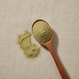 Aloe Powder (Aloe Ferox) | Create a luxurious, photorealistic product photograph featuring the original product naturally arranged in an elegant handcrafted wooden spoon on a soft, finely