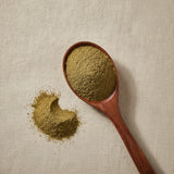 Amla Berry Powder (Phyllanthus Emblica) | Create a luxurious, photorealistic product photograph featuring the original product naturally arranged in an elegant handcrafted wooden spoon on a soft, finely