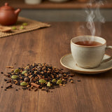 Apple Cinnamon Herbal Tea (Aspalathus Linearis) | Can you show this tea outside of the bag and bowl, on a table next to a hot tea cup in a rustic home.