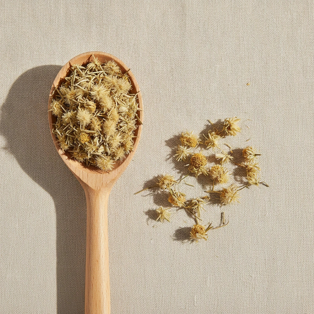 Arnica Flowers Whole (Heteroteca Inuloides) | Create a luxurious, photorealistic product photograph featuring the original product naturally arranged in an elegant handcrafted wooden spoon on a soft, finely