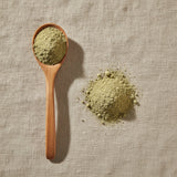 Artichoke Leaf Powder (Cynara Scolymus) | Create a luxurious, photorealistic product photograph featuring the original product naturally arranged in an elegant handcrafted wooden spoon on a soft, finely