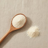 Ascorbyl Palmitate Powder (Ascorbic Acid 6-Palmitate) | Create a luxurious, photorealistic product photograph featuring the original product naturally arranged in an elegant handcrafted wooden spoon on a soft, finely