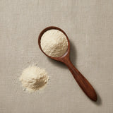 Ashwagandha Root Powder (Withania Somnifera) | Create a luxurious, photorealistic product photograph featuring the original product naturally arranged in an elegant handcrafted wooden spoon on a soft, finely