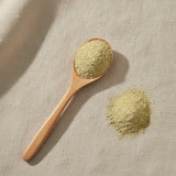 Asparagus Extract Powder (Asparagus Officinalis) | Create a luxurious, photorealistic product photograph featuring the original product naturally arranged in an elegant handcrafted wooden spoon on a soft, finely
