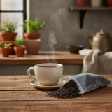 Assam Black Tea (Kondoli) (Camellia Sinensis) | Can you show this tea outside of the bag and bowl, on a table next to a hot tea cup in a rustic home.