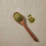 Atlantic Irish Moss Powder (Chondrus Crispus) | Create a luxurious, photorealistic product photograph featuring the original product naturally arranged in an elegant handcrafted wooden spoon on a soft, finely
