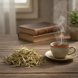 Bai Mu Dan White Tea (Camellia Sinensis) | Can you show this tea outside of the bag and bowl, on a table next to a hot tea cup in a rustic home.
