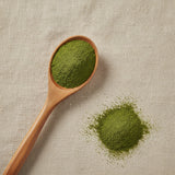 Barbed Skullcap Herb Powder (Scutellaria Barbata) | Create a luxurious, photorealistic product photograph featuring the original product naturally arranged in an elegant handcrafted wooden spoon on a soft, finely