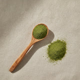 Basil Leaf Powder (Ocimum Basilicum) | Create a luxurious, photorealistic product photograph featuring the original product naturally arranged in an elegant handcrafted wooden spoon on a soft, finely