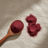 Beet Root Powder (Beta Vulgaris) | Create a luxurious, photorealistic product photograph featuring the original product naturally arranged in an elegant handcrafted wooden spoon on a soft, finely
