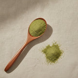 Bitter Melon Powder (Momordica Charantia) | Create a luxurious, photorealistic product photograph featuring the original product naturally arranged in an elegant handcrafted wooden spoon on a soft, finely