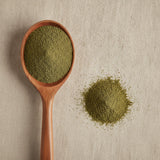 Bladderwrack Powder (Fucus Vesiculosus) | Create a luxurious, photorealistic product photograph featuring the original product naturally arranged in an elegant handcrafted wooden spoon on a soft, finely