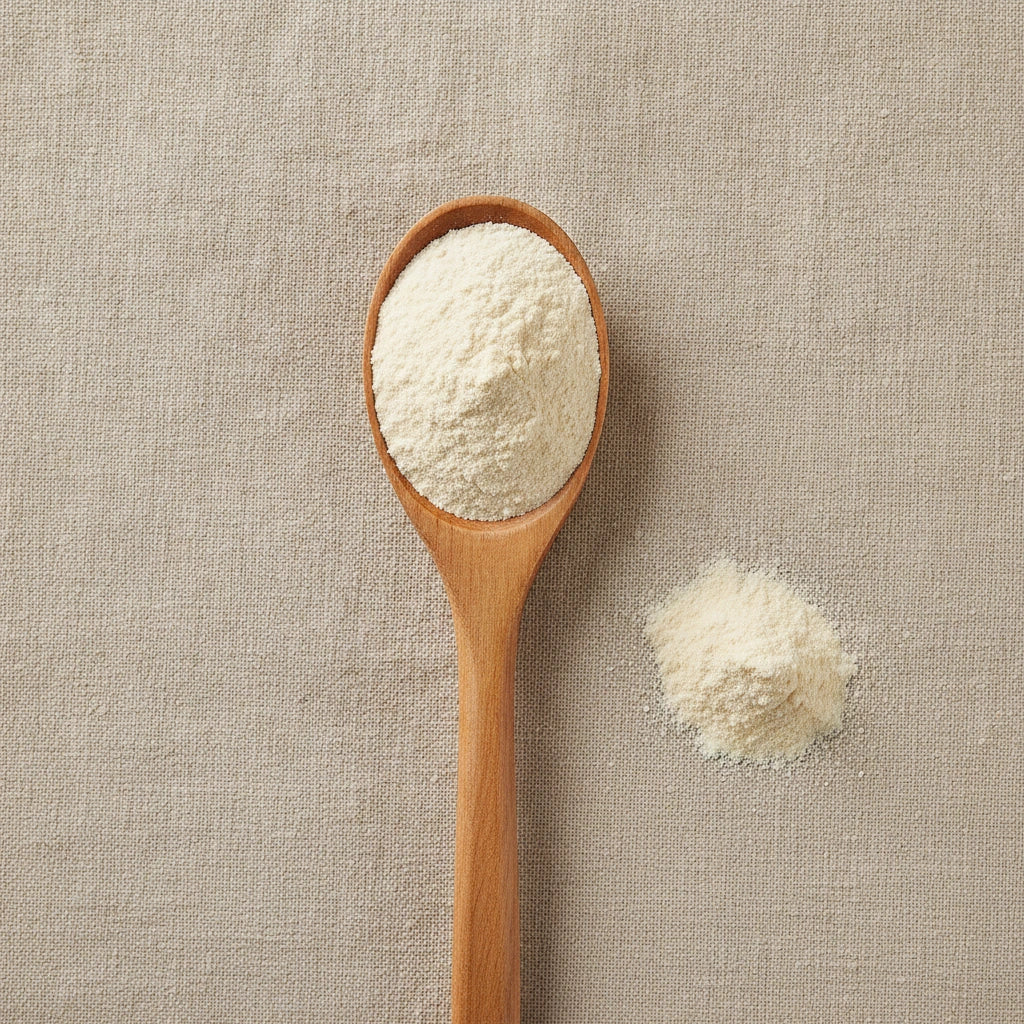 Bovine Colostrum Powder (Bos Taurus) | Create a luxurious, photorealistic product photograph featuring the original product naturally arranged in an elegant handcrafted wooden spoon on a soft, finely