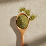 Brahmi Powder (Bacopa Monnieri) | Create a luxurious, photorealistic product photograph featuring the original product naturally arranged in an elegant handcrafted wooden spoon on a soft, finely