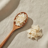 Broken Bone Flower Whole (Oroxylum Indicum) | Create a luxurious, photorealistic product photograph featuring the original product naturally arranged in an elegant handcrafted wooden spoon on a soft, finely