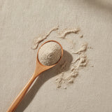 Bugleweed Herb Powder (Lycopus Lucidus) | Create a luxurious, photorealistic product photograph featuring the original product naturally arranged in an elegant handcrafted wooden spoon on a soft, finely