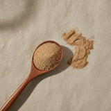 Bupleurum Root Powder (Bupleurum Scorzonerifolium) | Create a luxurious, photorealistic product photograph featuring the original product naturally arranged in an elegant handcrafted wooden spoon on a soft, finely