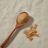 Butcher's Broom Root Powder (Ruscus Aculeatus) | Create a luxurious, photorealistic product photograph featuring the original product naturally arranged in an elegant handcrafted wooden spoon on a soft, finely