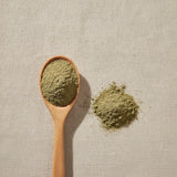 Catnip Leaf & Flower Powder (Nepeta Cataria) | Create a luxurious, photorealistic product photograph featuring the original product naturally arranged in an elegant handcrafted wooden spoon on a soft, finely