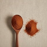 Catuaba Bark Powder (Erythroxylum Catuaba) | Create a luxurious, photorealistic product photograph featuring the original product naturally arranged in an elegant handcrafted wooden spoon on a soft, finely
