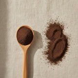 Chaga Mushroom Powder (Inonotus Obliquus) | Create a luxurious, photorealistic product photograph featuring the original product naturally arranged in an elegant handcrafted wooden spoon on a soft, finely