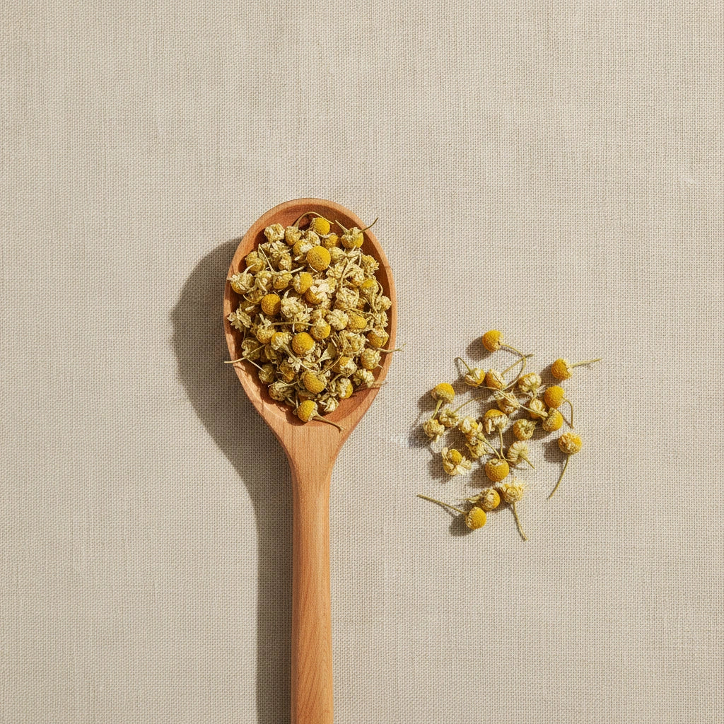 Chamomile Flowers Whole (Matricaria Camomilla) | Create a luxurious, photorealistic product photograph featuring the original product naturally arranged in an elegant handcrafted wooden spoon on a soft, finely