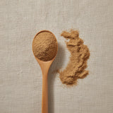Chinese Dittany Bark Powder (Dictamnus Dasycarpus) | Create a luxurious, photorealistic product photograph featuring the original product naturally arranged in an elegant handcrafted wooden spoon on a soft, finely