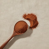Chinese Salvia Root Powder (Salvia Miltiorrhiza) | Create a luxurious, photorealistic product photograph featuring the original product naturally arranged in an elegant handcrafted wooden spoon on a soft, finely