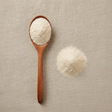 Chinese Yam Powder (Dioscorea Opposita) | Create a luxurious, photorealistic product photograph featuring the original product naturally arranged in an elegant handcrafted wooden spoon on a soft, finely