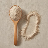 Coix Seed Powder (Coix Lacryma-Jobi Var. Ma-Yuen) | Create a luxurious, photorealistic product photograph featuring the original product naturally arranged in an elegant handcrafted wooden spoon on a soft, finely
