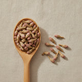 Coltsfoot Flower Whole (Tussilago Farfara) | Create a luxurious, photorealistic product photograph featuring the original product naturally arranged in an elegant handcrafted wooden spoon on a soft, finely