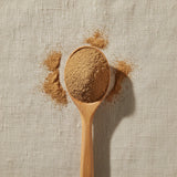 Cordyceps Mushroom Powder (Cordyceps Sinensis) | Create a luxurious, photorealistic product photograph featuring the original product naturally arranged in an elegant handcrafted wooden spoon on a soft, finely