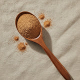 Cornsilk Powder (Zea Mays) | Create a luxurious, photorealistic product photograph featuring the original product naturally arranged in an elegant handcrafted wooden spoon on a soft, finely