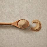 Cramp Bark Powder (Viburnum Opulus) | Create a luxurious, photorealistic product photograph featuring the original product naturally arranged in an elegant handcrafted wooden spoon on a soft, finely