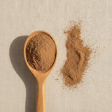 Cuachalalate Bark Powder (Amphipterygium Adstringens) | Create a luxurious, photorealistic product photograph featuring the original product naturally arranged in an elegant handcrafted wooden spoon on a soft, finely