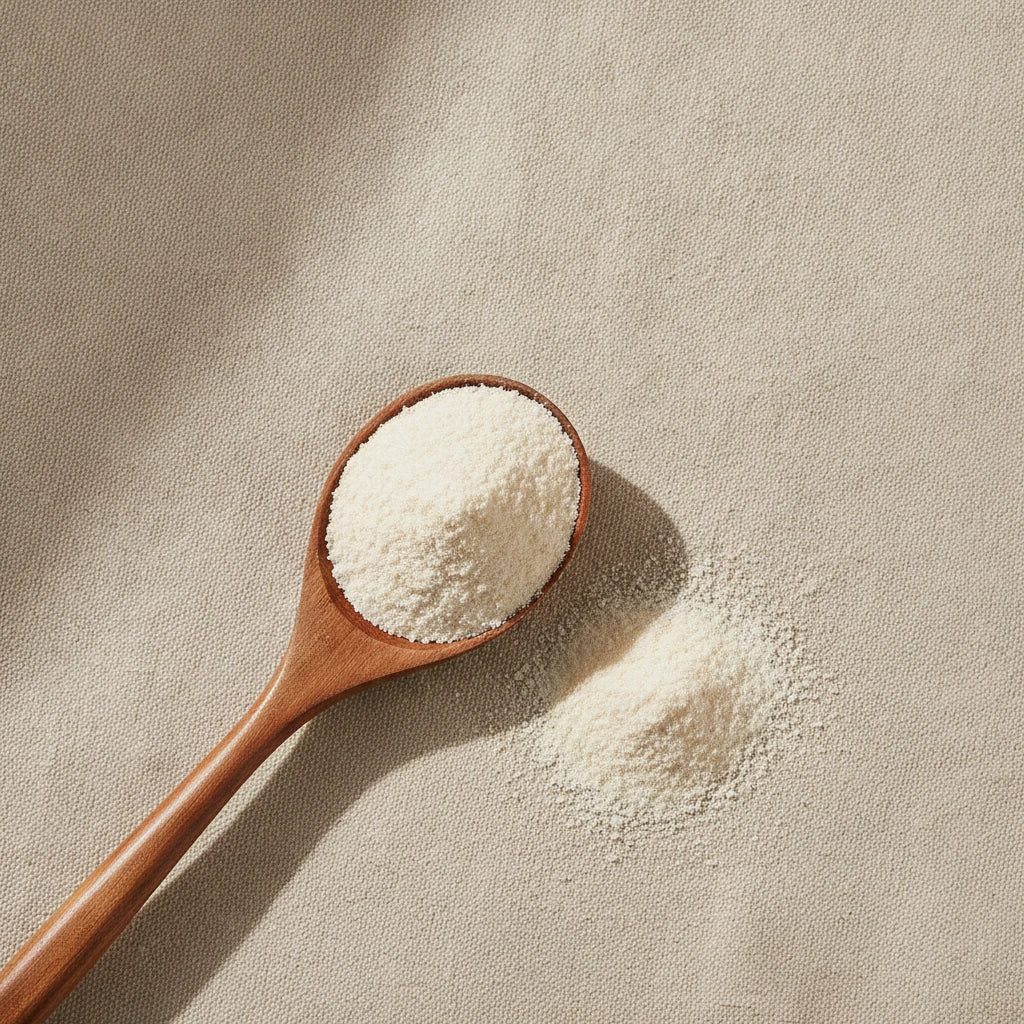 Cuttlefish Bone Powder (Sepia Esculenta) | Create a luxurious, photorealistic product photograph featuring the original product naturally arranged in an elegant handcrafted wooden spoon on a soft, finely