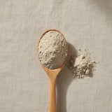 Devil's Claw Root Powder (Harpagophytum Procumbens) | Create a luxurious, photorealistic product photograph featuring the original product naturally arranged in an elegant handcrafted wooden spoon on a soft, finely
