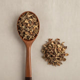 Devil's Hand Flower Whole (Chiranthodendron Pentadactylon) | Create a luxurious, photorealistic product photograph featuring the original product naturally arranged in an elegant handcrafted wooden spoon on a soft, finely