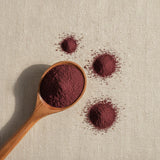 Dulse Powder (Palmaria Palmata) | Create a luxurious, photorealistic product photograph featuring the original product naturally arranged in an elegant handcrafted wooden spoon on a soft, finely