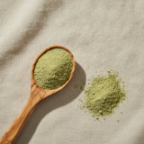 Eucalyptus Leaf Powder (Eucalyptus Globulus) | Create a luxurious, photorealistic product photograph featuring the original product naturally arranged in an elegant handcrafted wooden spoon on a soft, finely