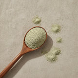 Eyebright Herb Powder (Euphrasia Officinalis) | Create a luxurious, photorealistic product photograph featuring the original product naturally arranged in an elegant handcrafted wooden spoon on a soft, finely