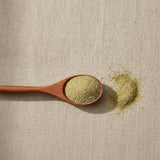Fennel Seed Powder (Foeniculum Vulgare) | Create a luxurious, photorealistic product photograph featuring the original product naturally arranged in an elegant handcrafted wooden spoon on a soft, finely