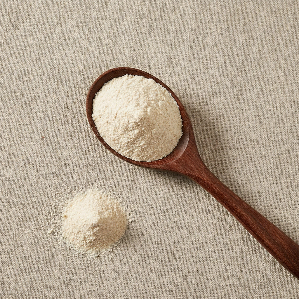 Garlic Powder (Allium Sativum) | Create a luxurious, photorealistic product photograph featuring the original product naturally arranged in an elegant handcrafted wooden spoon on a soft, finely
