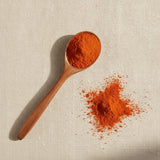 Goji Juice Powder (Lycium Barbarum) | Create a luxurious, photorealistic product photograph featuring the original product naturally arranged in an elegant handcrafted wooden spoon on a soft, finely