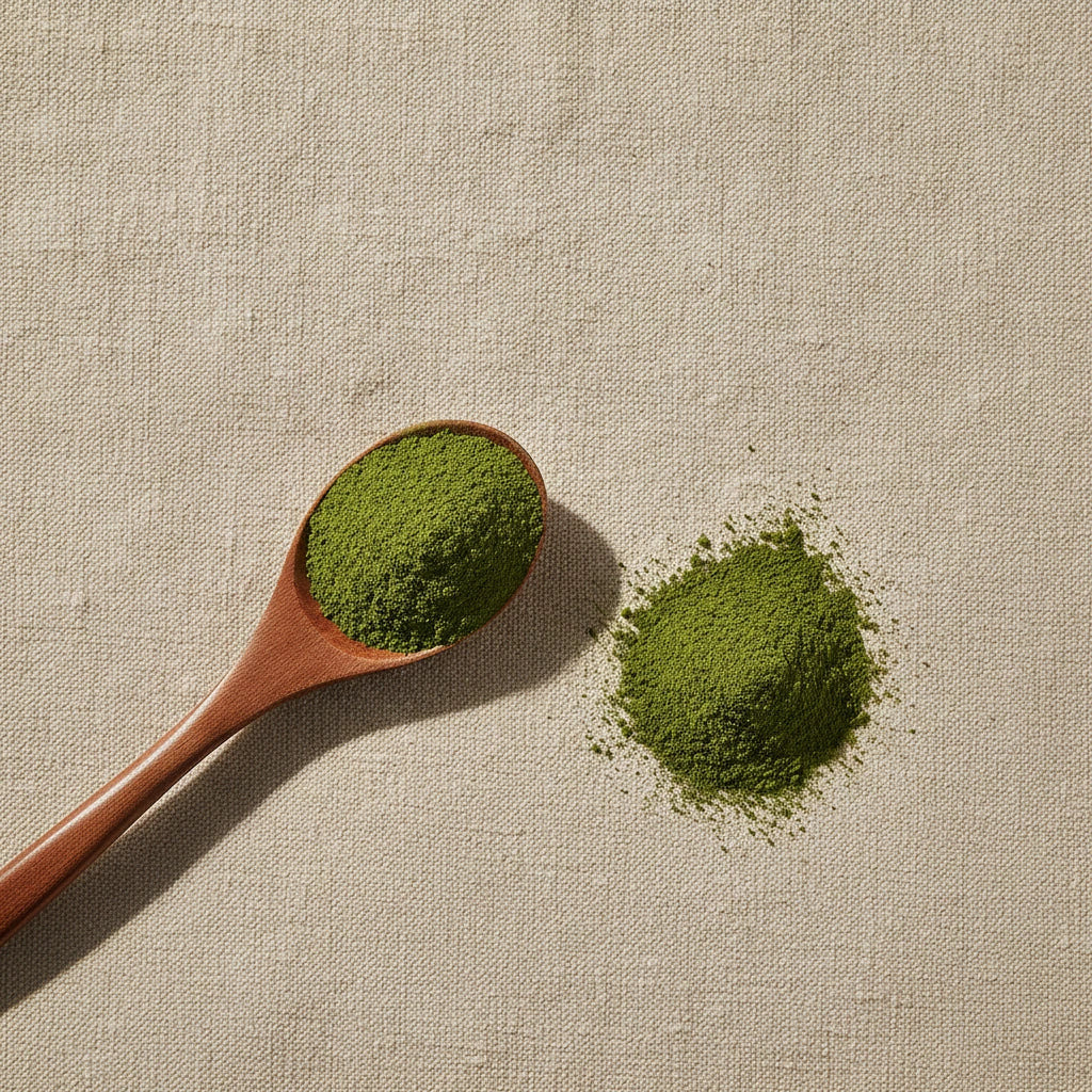 Green Tea Powder (Camillia Sinensis) | Create a luxurious, photorealistic product photograph featuring the original product naturally arranged in an elegant handcrafted wooden spoon on a soft, finely